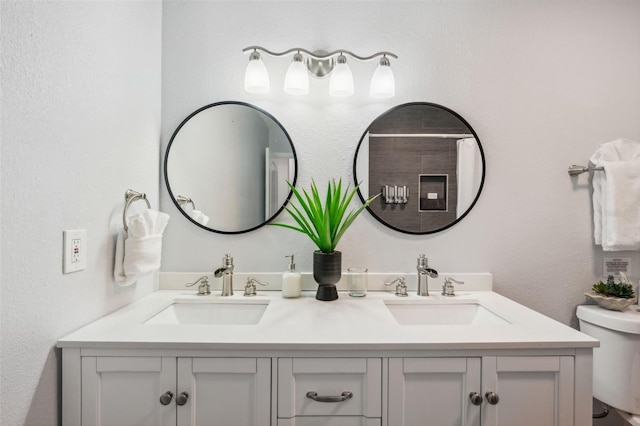 bathroom featuring toilet and vanity