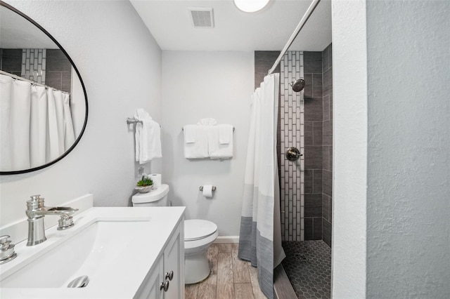 bathroom with toilet, vanity, and a shower with shower curtain