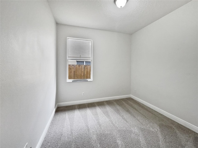 spare room with carpet flooring and a textured ceiling