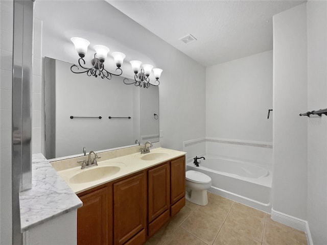 bathroom with a bathtub, vanity, a textured ceiling, tile patterned floors, and toilet