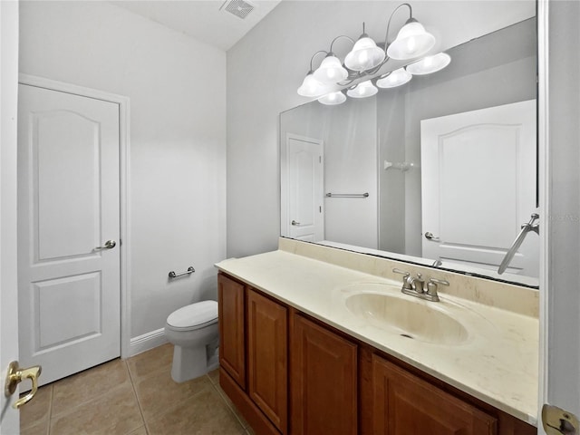 bathroom featuring vanity, tile patterned floors, and toilet