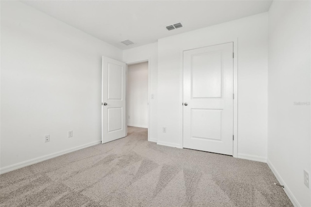 unfurnished bedroom featuring light carpet