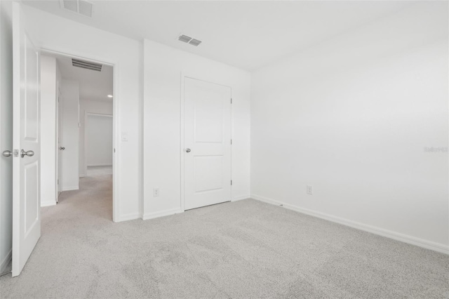 unfurnished bedroom with light colored carpet