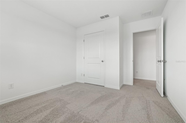 unfurnished bedroom featuring light carpet