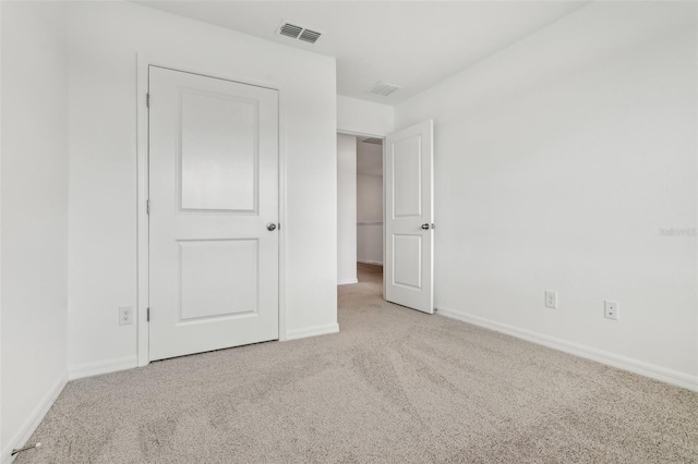 unfurnished bedroom featuring light colored carpet