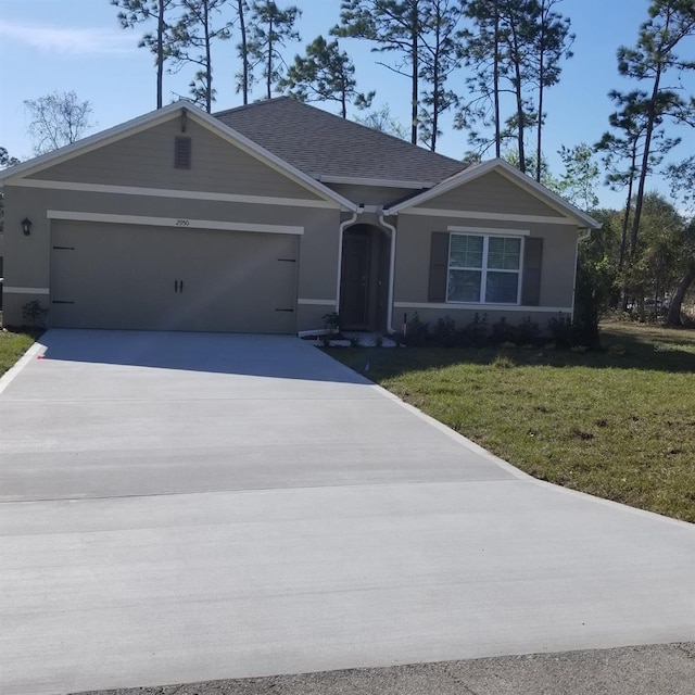 ranch-style home with a garage and a front yard