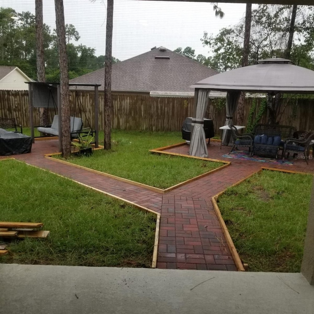 view of yard with an outdoor living space and a gazebo