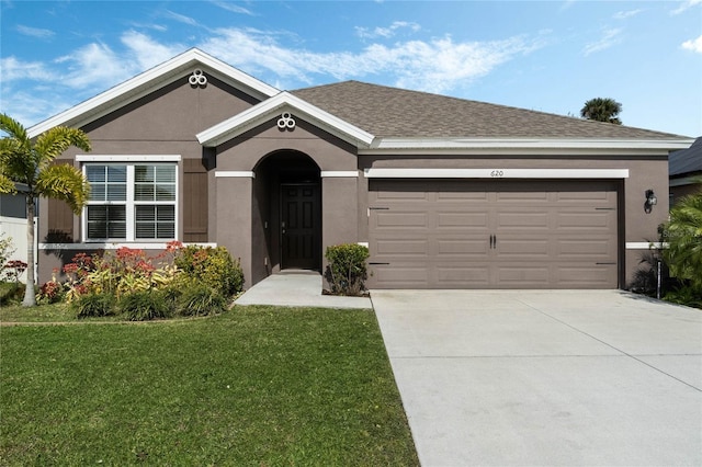 single story home with a garage and a front yard