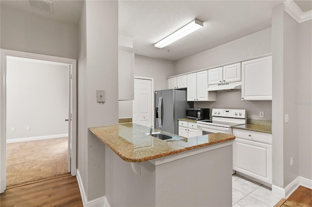 kitchen with a breakfast bar area, stainless steel appliances, light stone counters, white cabinets, and kitchen peninsula