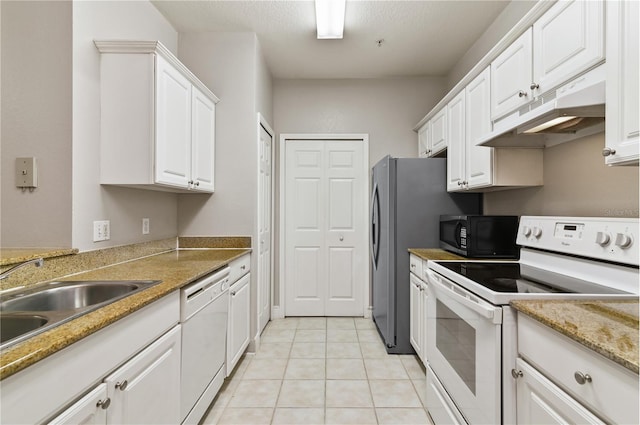 kitchen with sink, white cabinets, light tile patterned flooring, white appliances, and stone counters