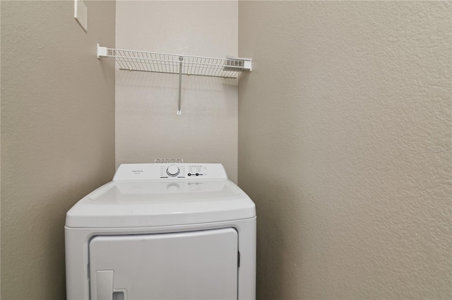 clothes washing area featuring washer / dryer