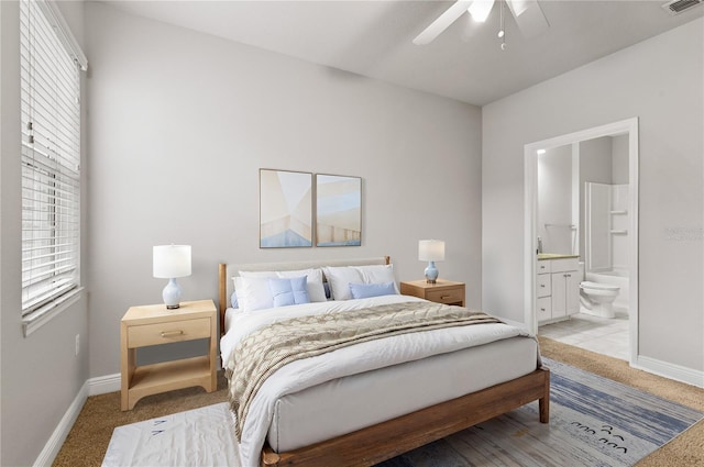 bedroom featuring ceiling fan, carpet floors, and ensuite bath