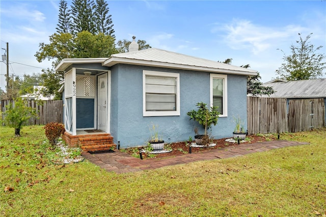 bungalow with a front yard