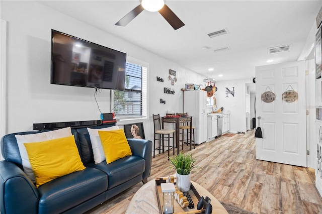 living room with ceiling fan and light wood-type flooring