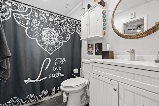 bathroom featuring tile patterned flooring, vanity, and toilet