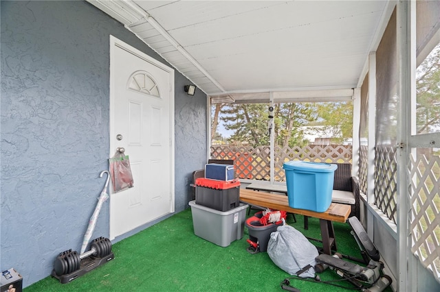 sunroom featuring lofted ceiling