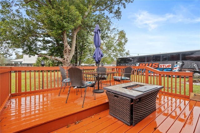 wooden deck featuring an outdoor fire pit