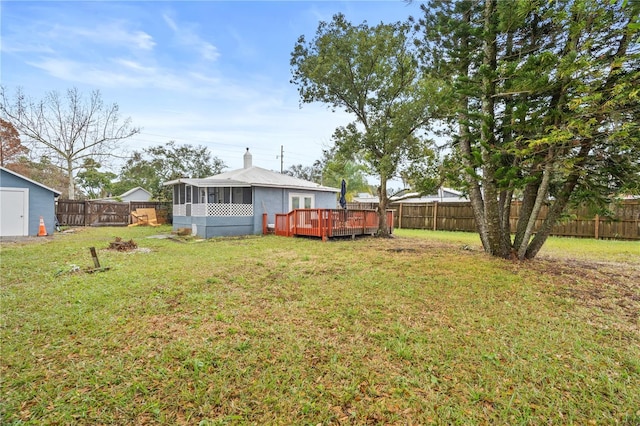 view of yard featuring a deck and a sunroom