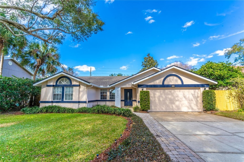 ranch-style home featuring a garage and a front yard