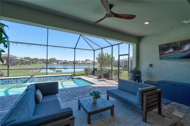 view of swimming pool with a patio, glass enclosure, ceiling fan, grilling area, and an outdoor hangout area