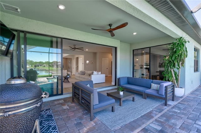 view of patio / terrace with ceiling fan, an outdoor living space, and area for grilling