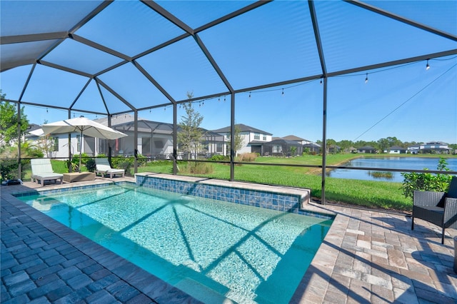 view of swimming pool featuring glass enclosure, a water view, a lawn, and a patio