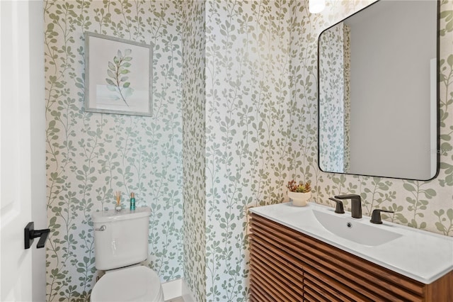 bathroom featuring vanity and toilet