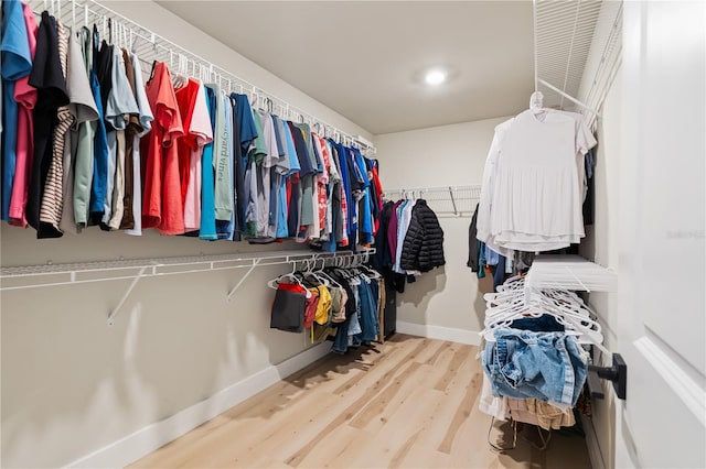 spacious closet with light hardwood / wood-style floors