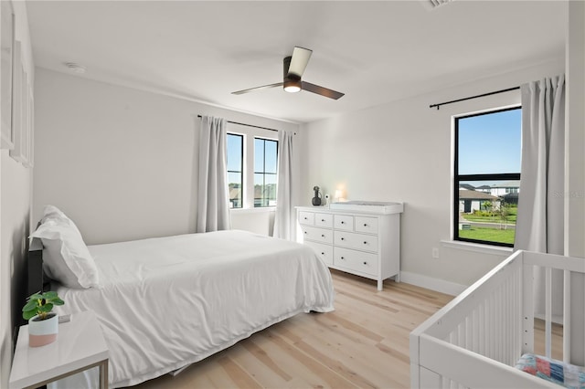 bedroom with ceiling fan and light wood-type flooring