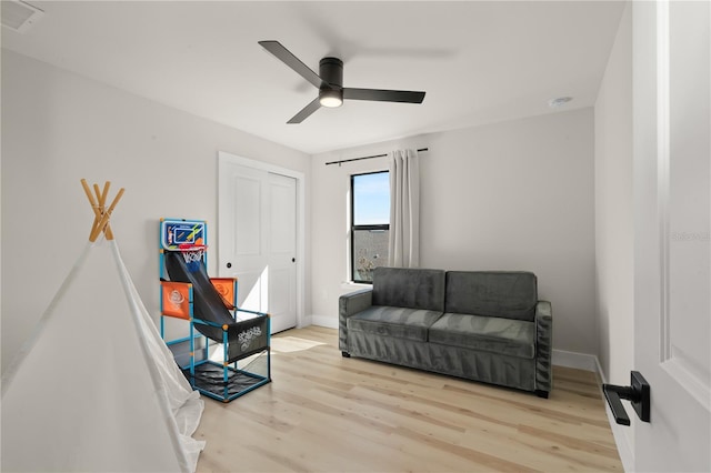 sitting room featuring ceiling fan and light wood-type flooring