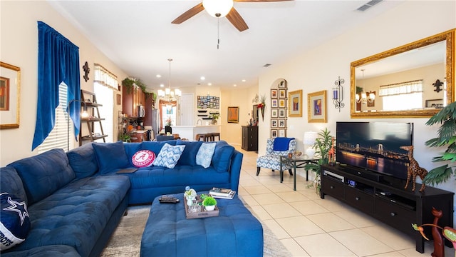 living room with ceiling fan with notable chandelier and light tile patterned flooring