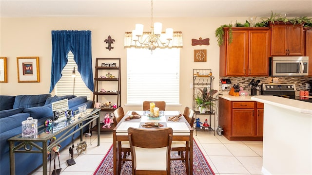 dining room with a healthy amount of sunlight, a chandelier, and light tile patterned floors