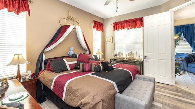 bedroom with light wood-type flooring and ceiling fan