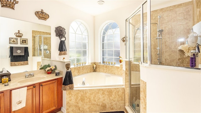 bathroom featuring vanity and shower with separate bathtub