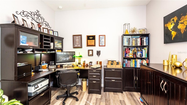 office with light wood-type flooring