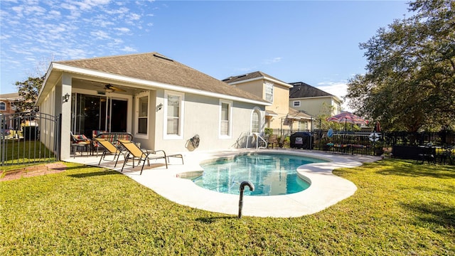 back of house featuring ceiling fan, a yard, a fenced in pool, and a patio