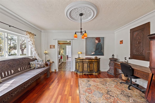 office space featuring crown molding, hardwood / wood-style floors, a notable chandelier, and a textured ceiling