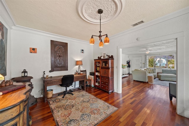 office space featuring ceiling fan with notable chandelier, ornamental molding, dark hardwood / wood-style floors, and a textured ceiling