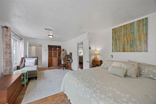 bedroom featuring hardwood / wood-style flooring and a textured ceiling