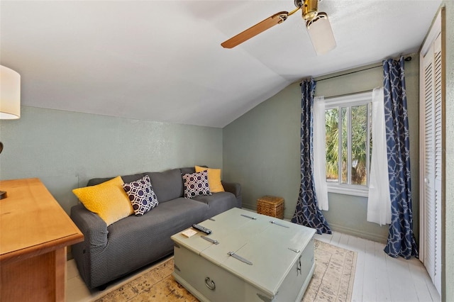 living room with vaulted ceiling, light wood-type flooring, and ceiling fan