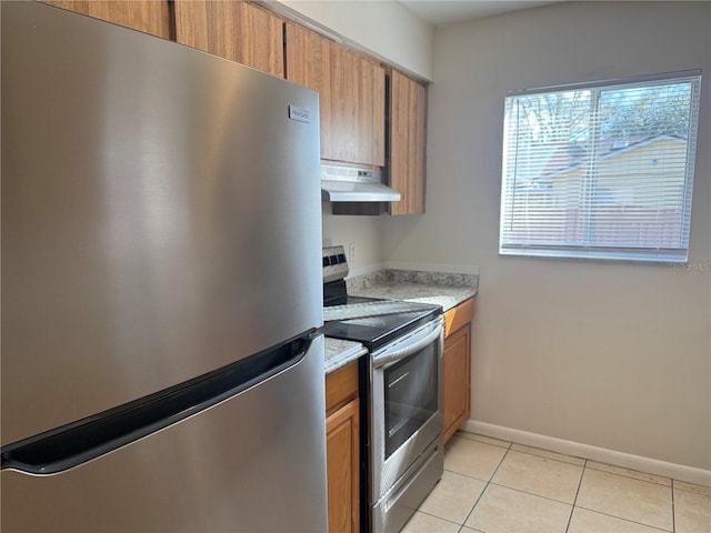 kitchen with light tile patterned flooring and appliances with stainless steel finishes