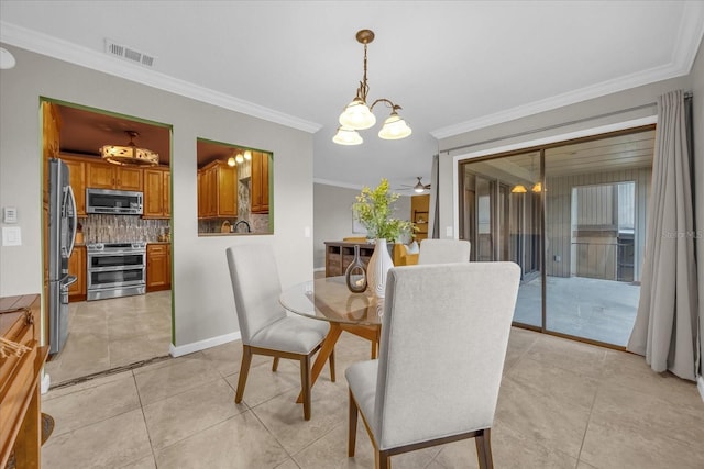 dining area with crown molding, ceiling fan with notable chandelier, and light tile patterned flooring