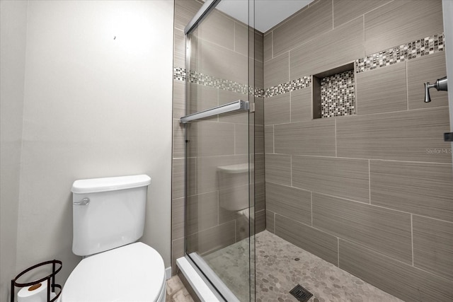 bathroom featuring an enclosed shower and toilet