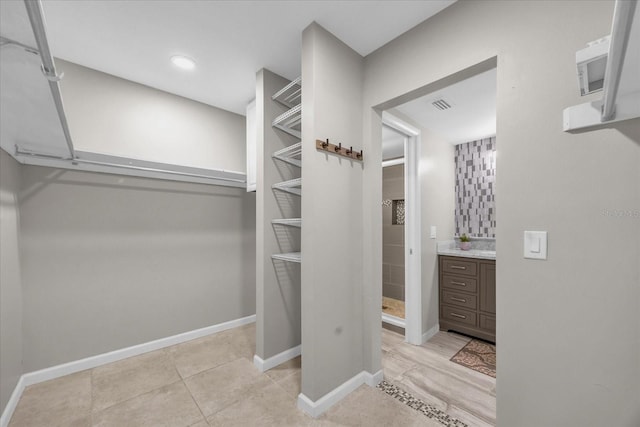 spacious closet with light tile patterned flooring