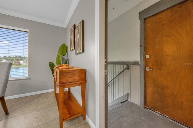 hall featuring light tile patterned floors and ornamental molding