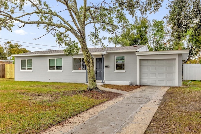 ranch-style home featuring a garage and a front yard