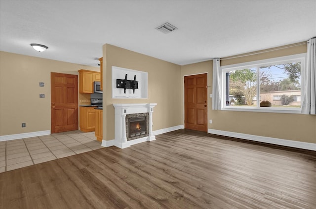 unfurnished living room featuring light wood-type flooring