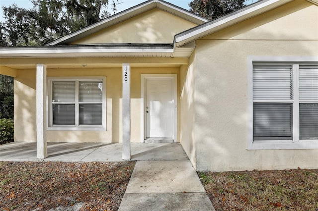 view of exterior entry with covered porch