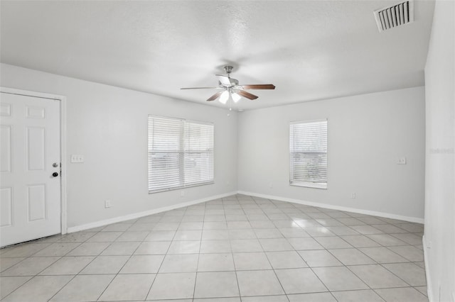 unfurnished room featuring light tile patterned floors and ceiling fan