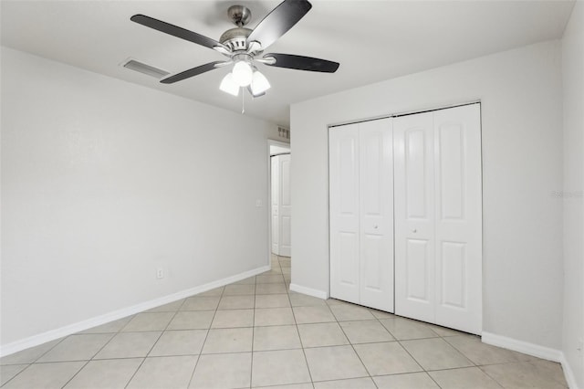 unfurnished bedroom with a closet, ceiling fan, and light tile patterned floors